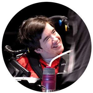 Woman in red shirt sitting in wheelchair smiling